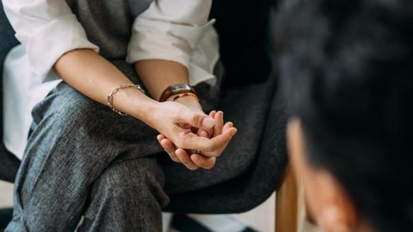Close-up of woman's hands during counseling meeting with a professio<em></em>nal therapist.