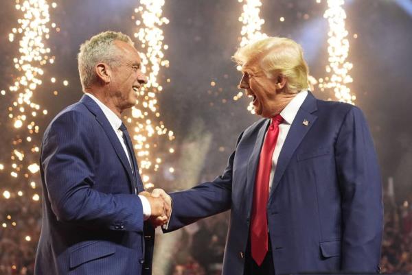Former President Do<em></em>nald Trump shaking hands with Robert F. Kennedy Jr. on a stage with fireworks in the background at a campaign rally in Glendale, Arizona, 2024