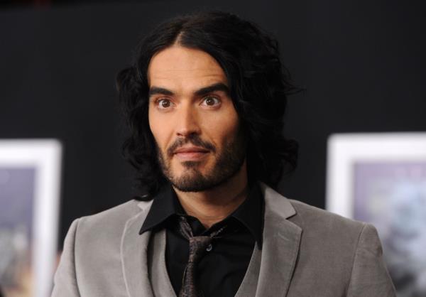 actor Russell Brand arrive at the premiere of Touchstone Pictures and Miramax Films' 'The Tempest' at the El Capitan Theatre