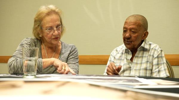 Mrs McKay and Hosein look through photos of the farm