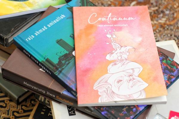 A stack of books by written Raja Ahmad, including 'Continuum', a collection of English poems with a Malay touch, which was launched in February this year. Photo: The Star/Muhamad Shahril Rosli