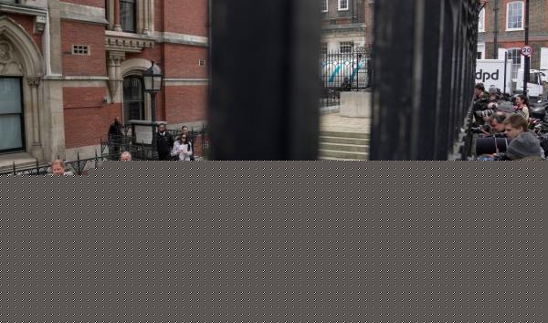 FILE - Britain's Prince Harry leaves the Royal Courts Of Justice as journalists look through a fence in London, Thursday, March 30, 2023.Prince Harry is challenging on Tuesday, Dec. 5, 2023, the British government’s decision to strip him of his security detail after he gave up his status as a working member of the royal family and moved to the United States. The Duke of Sussex said he wants protection when he visits home and claimed it's partly because an aggressive press jeopardizes his safety and that of his family. (AP Photo/Kin Cheung, File)