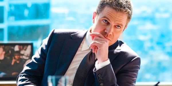 Stephen Amell with his hand on his chin in Suits LA